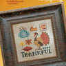 Cross-stitched design with 'Thankful' text in a rustic frame on a yellow background, featuring Heart in Hand branding.