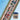 Cross-stitched design of a town with a small container on a blue background, featuring 'Heart of a Hand' branding.