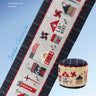 Cross-stitched table runner with patriotic design and matching ottoman on a blue background, featuring 'Heart in Hand' brand.